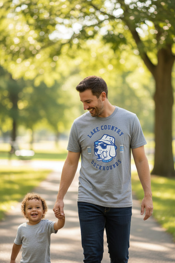 Gray t-shirt with 'Lake Country Dockhounds' logo on a hanger in a store setting.