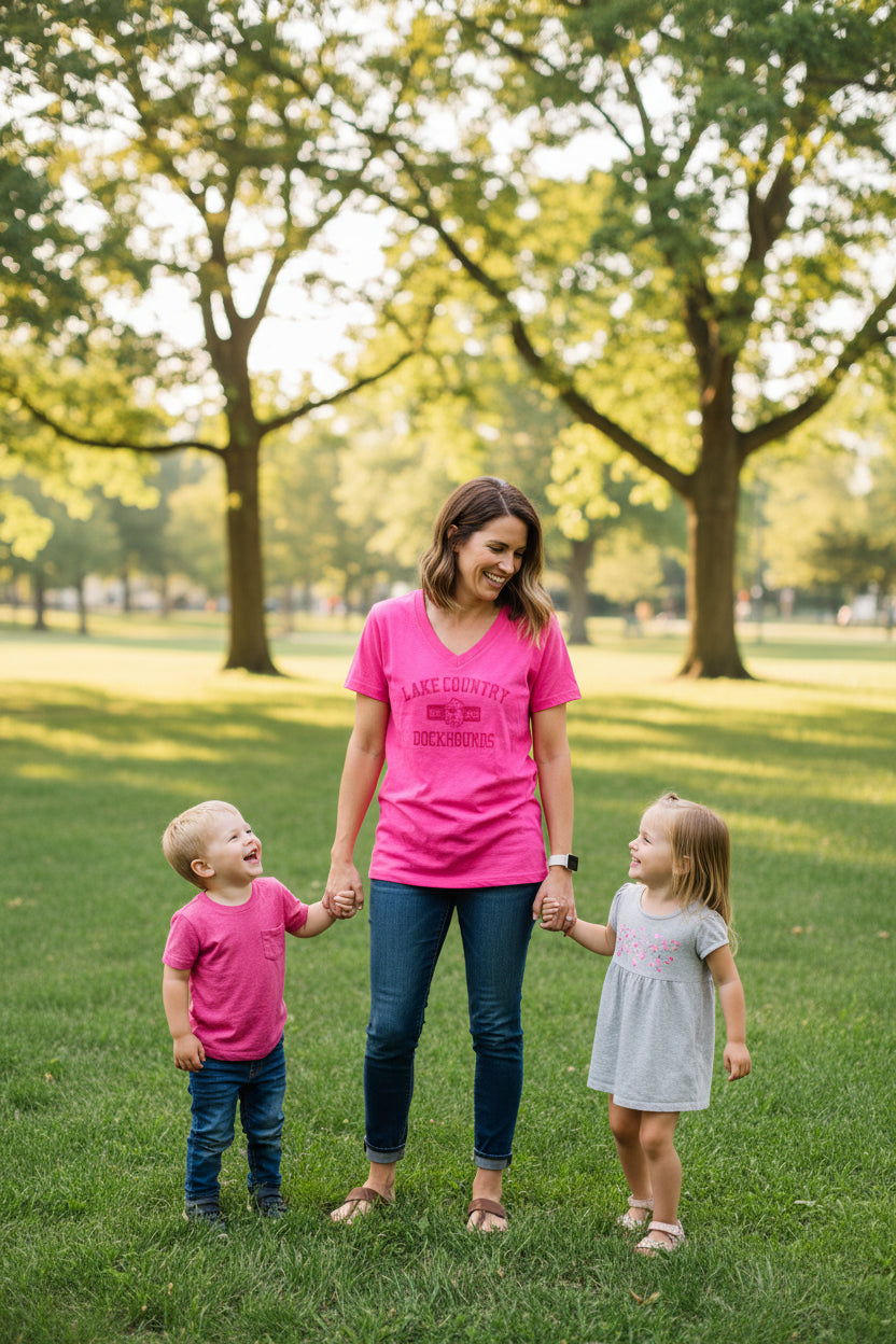Pink t-shirt with 'Lake Country Dockhounds' text on a hanger.