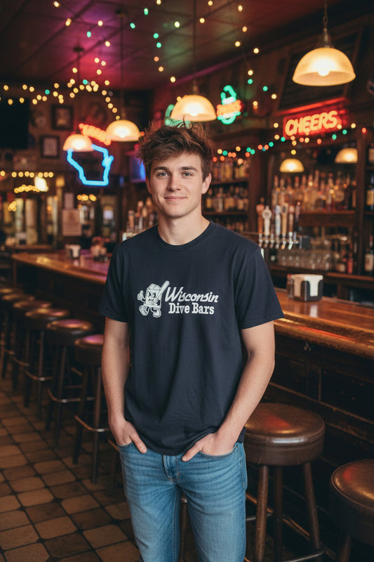 Black t-shirt with 'Wisconsin Dive Bars' text on a hanger in a store setting.